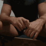 a man feeling a butt plug in his hands