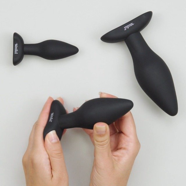 butt plugs by sinful. Three butt plugs and ladys hand